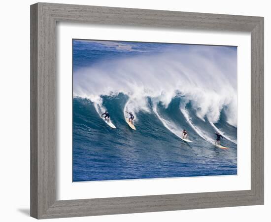 Surfers Ride a Wave at Waimea Beach on the North Shore of Oahu, Hawaii-null-Framed Photographic Print