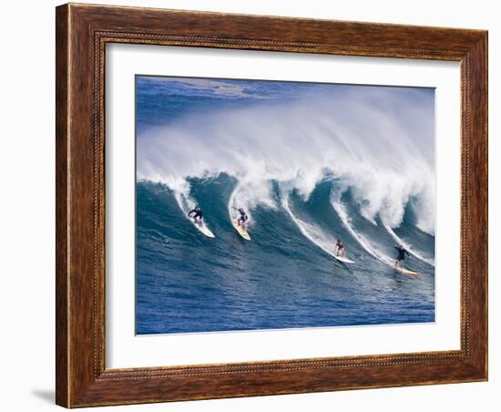 Surfers Ride a Wave at Waimea Beach on the North Shore of Oahu, Hawaii-null-Framed Photographic Print