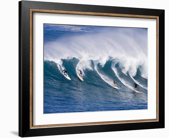 Surfers Ride a Wave at Waimea Beach on the North Shore of Oahu, Hawaii-null-Framed Photographic Print