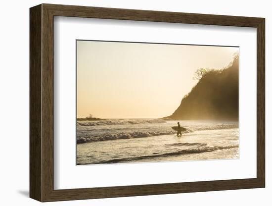 Surfers surfing on a beach at sunset, Nosara, Guanacaste Province, Pacific Coast, Costa Rica-Matthew Williams-Ellis-Framed Photographic Print