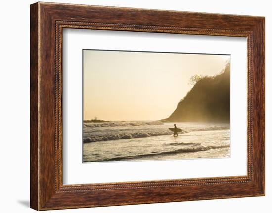 Surfers surfing on a beach at sunset, Nosara, Guanacaste Province, Pacific Coast, Costa Rica-Matthew Williams-Ellis-Framed Photographic Print