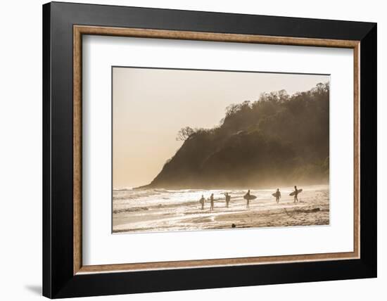 Surfers surfing on a beach at sunset, Nosara, Guanacaste Province, Pacific Coast, Costa Rica-Matthew Williams-Ellis-Framed Photographic Print