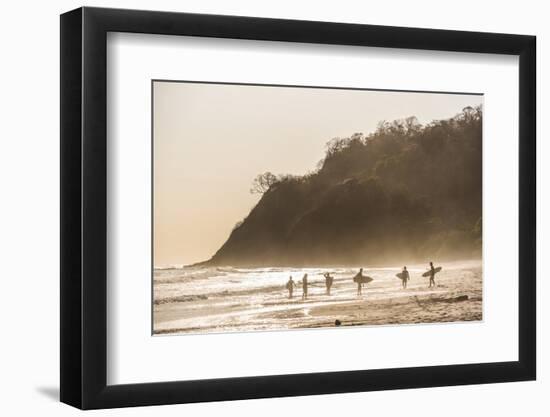 Surfers surfing on a beach at sunset, Nosara, Guanacaste Province, Pacific Coast, Costa Rica-Matthew Williams-Ellis-Framed Photographic Print