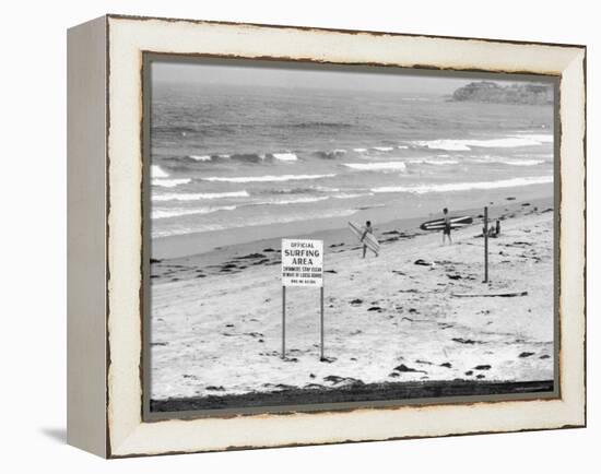 Surfers Walking to Water Behind Sign Reading "Official Surfing Area"-Allan Grant-Framed Premier Image Canvas