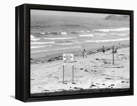 Surfers Walking to Water Behind Sign Reading "Official Surfing Area"-Allan Grant-Framed Premier Image Canvas