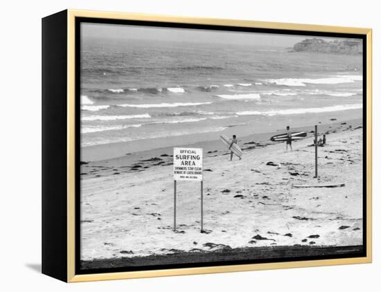 Surfers Walking to Water Behind Sign Reading "Official Surfing Area"-Allan Grant-Framed Premier Image Canvas