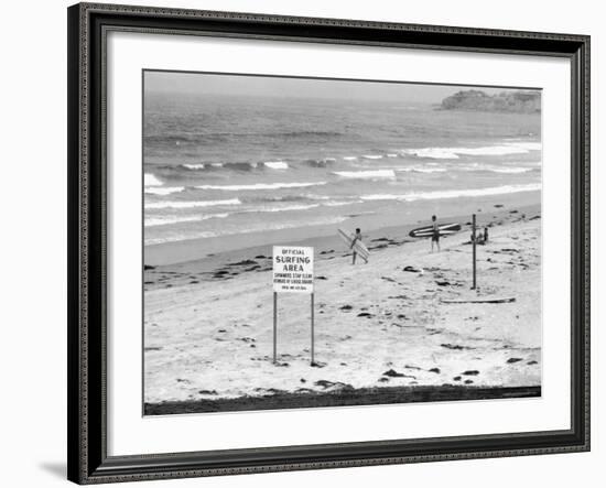 Surfers Walking to Water Behind Sign Reading "Official Surfing Area"-Allan Grant-Framed Photographic Print
