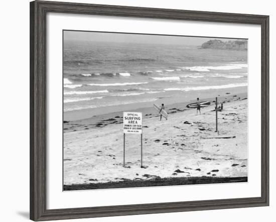 Surfers Walking to Water Behind Sign Reading "Official Surfing Area"-Allan Grant-Framed Photographic Print