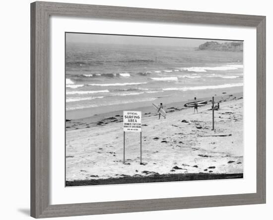 Surfers Walking to Water Behind Sign Reading "Official Surfing Area"-Allan Grant-Framed Photographic Print