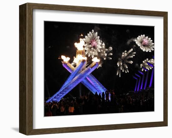Surrounding the Olympic Flame as Fireworks Explode after the Opening Ceremony of 2010 Winter Games-null-Framed Photographic Print