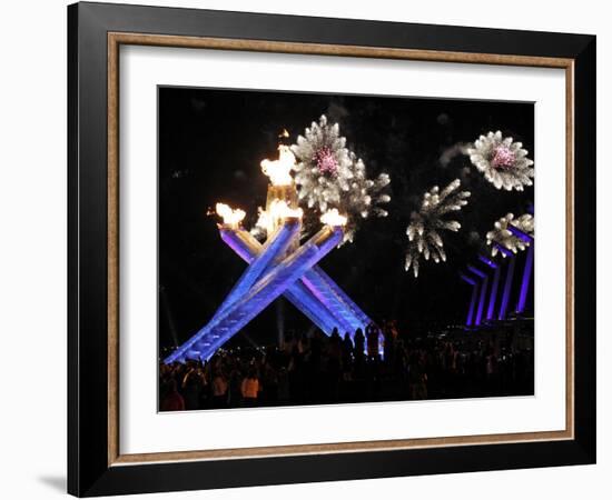 Surrounding the Olympic Flame as Fireworks Explode after the Opening Ceremony of 2010 Winter Games-null-Framed Photographic Print