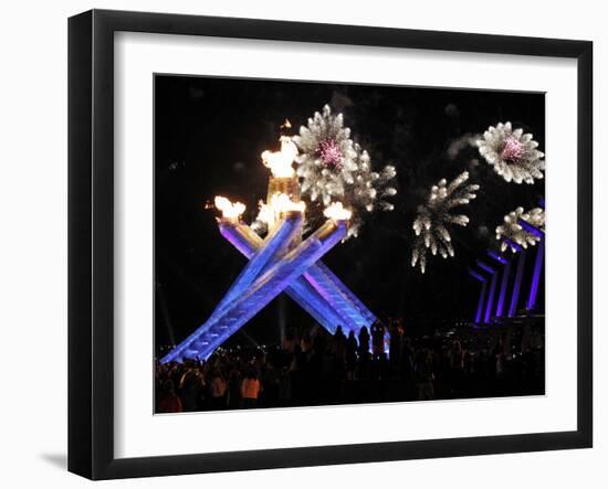 Surrounding the Olympic Flame as Fireworks Explode after the Opening Ceremony of 2010 Winter Games-null-Framed Photographic Print