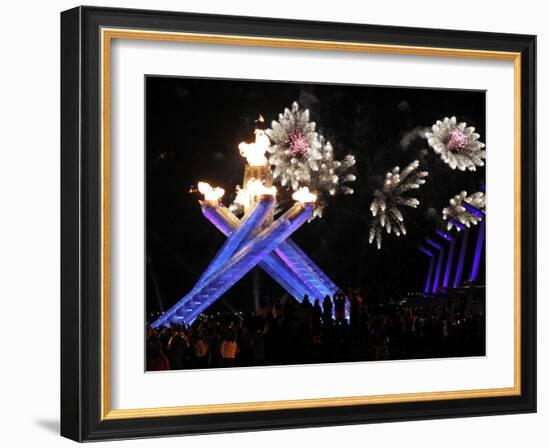 Surrounding the Olympic Flame as Fireworks Explode after the Opening Ceremony of 2010 Winter Games-null-Framed Photographic Print