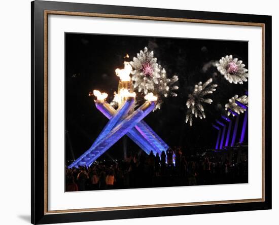 Surrounding the Olympic Flame as Fireworks Explode after the Opening Ceremony of 2010 Winter Games-null-Framed Photographic Print