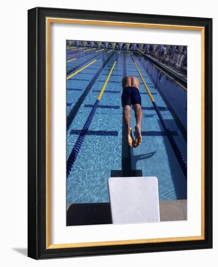 Swimmer Diving Off the Starting Blocks to Begin a Race-Steven Sutton-Framed Photographic Print