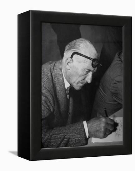 Swiss Architect Le Corbusier Leaning Down to Write with His Glasses Pushed Back on His Forehead-null-Framed Premier Image Canvas