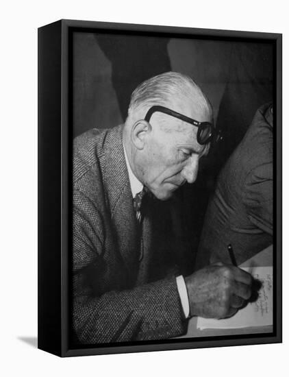 Swiss Architect Le Corbusier Leaning Down to Write with His Glasses Pushed Back on His Forehead-null-Framed Premier Image Canvas