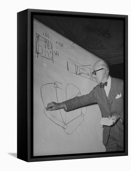 Swiss Architect Le Corbusier Standing on Stage with Notes in His Hand and Drawing on Sketch Pad-null-Framed Premier Image Canvas