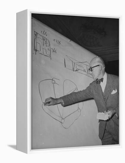 Swiss Architect Le Corbusier Standing on Stage with Notes in His Hand and Drawing on Sketch Pad-null-Framed Premier Image Canvas