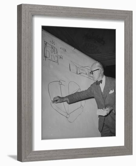 Swiss Architect Le Corbusier Standing on Stage with Notes in His Hand and Drawing on Sketch Pad-null-Framed Photographic Print