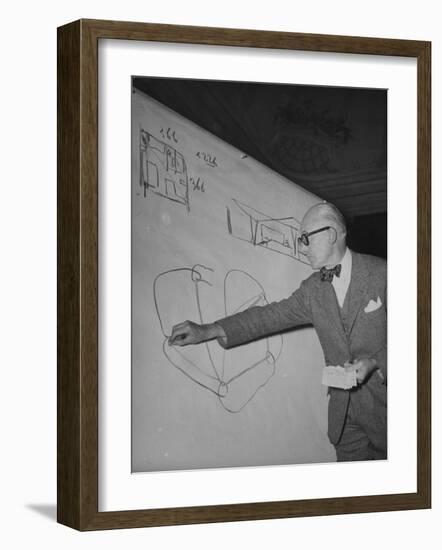 Swiss Architect Le Corbusier Standing on Stage with Notes in His Hand and Drawing on Sketch Pad-null-Framed Photographic Print