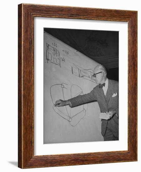 Swiss Architect Le Corbusier Standing on Stage with Notes in His Hand and Drawing on Sketch Pad-null-Framed Photographic Print