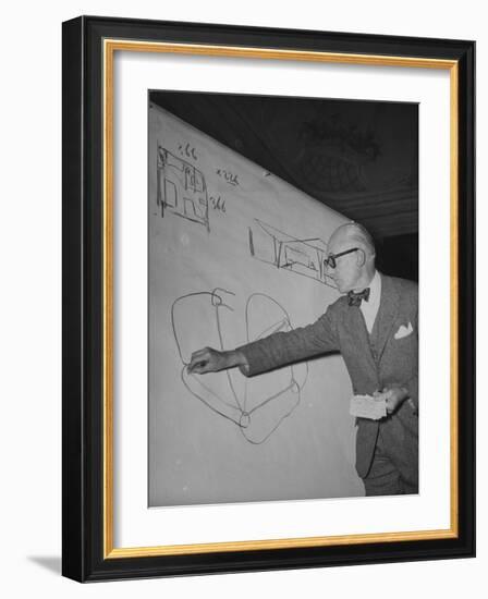 Swiss Architect Le Corbusier Standing on Stage with Notes in His Hand and Drawing on Sketch Pad-null-Framed Photographic Print