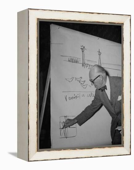 Swiss Architect Le Corbusier Standing on Stage with Notes in His Hand and Drawing on Sketch Pad-null-Framed Premier Image Canvas