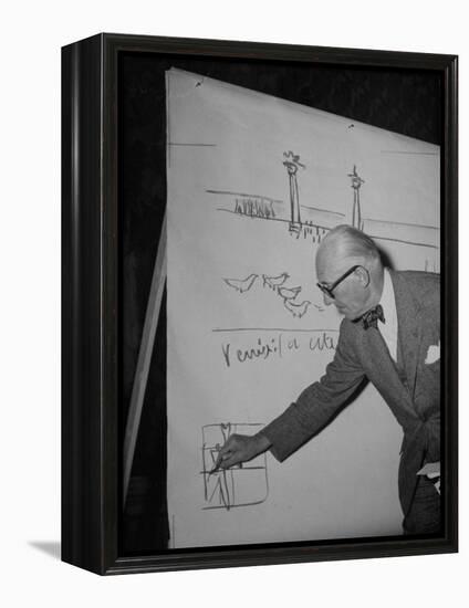 Swiss Architect Le Corbusier Standing on Stage with Notes in His Hand and Drawing on Sketch Pad-null-Framed Premier Image Canvas