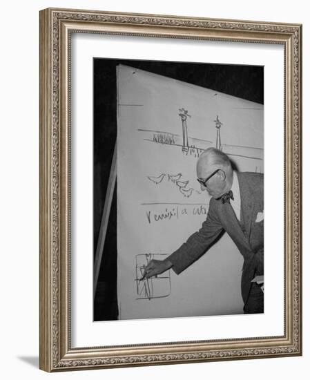 Swiss Architect Le Corbusier Standing on Stage with Notes in His Hand and Drawing on Sketch Pad-null-Framed Photographic Print