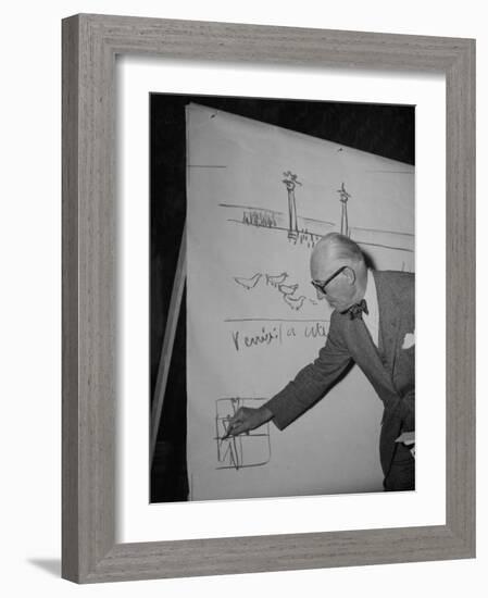 Swiss Architect Le Corbusier Standing on Stage with Notes in His Hand and Drawing on Sketch Pad-null-Framed Photographic Print