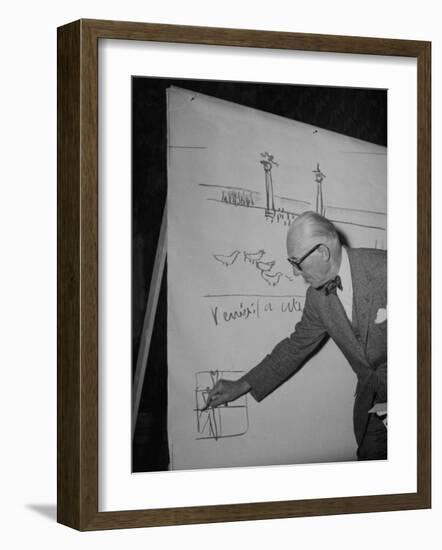 Swiss Architect Le Corbusier Standing on Stage with Notes in His Hand and Drawing on Sketch Pad-null-Framed Photographic Print