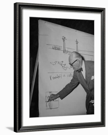 Swiss Architect Le Corbusier Standing on Stage with Notes in His Hand and Drawing on Sketch Pad-null-Framed Photographic Print