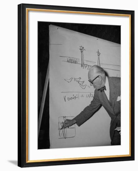 Swiss Architect Le Corbusier Standing on Stage with Notes in His Hand and Drawing on Sketch Pad-null-Framed Photographic Print