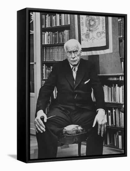 Swiss Psychiatrist Dr. Carl Jung Holding Pipe as He Sits on Chair in His Library at Home-Dmitri Kessel-Framed Premier Image Canvas