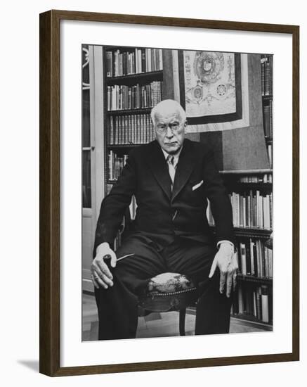 Swiss Psychiatrist Dr. Carl Jung Holding Pipe as He Sits on Chair in His Library at Home-Dmitri Kessel-Framed Premium Photographic Print