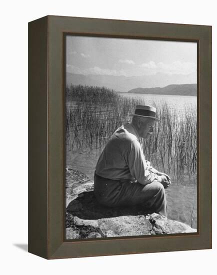 Swiss Psychiatrist Dr. Carl Jung Sitting on Stone Wall Overlooking Lake Zurich-Dmitri Kessel-Framed Premier Image Canvas