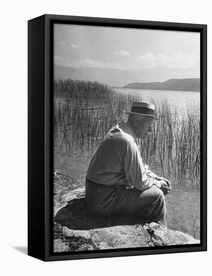 Swiss Psychiatrist Dr. Carl Jung Sitting on Stone Wall Overlooking Lake Zurich-Dmitri Kessel-Framed Premier Image Canvas