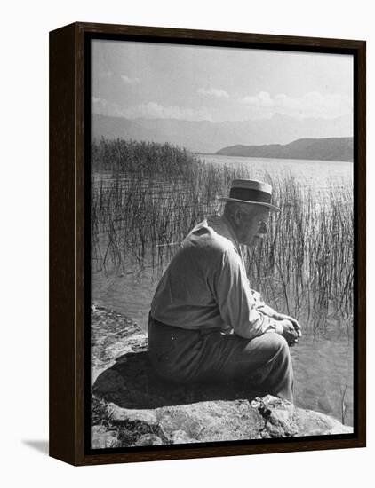 Swiss Psychiatrist Dr. Carl Jung Sitting on Stone Wall Overlooking Lake Zurich-Dmitri Kessel-Framed Premier Image Canvas