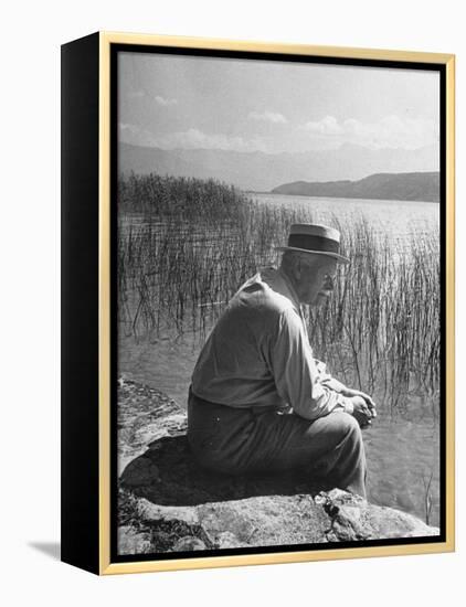 Swiss Psychiatrist Dr. Carl Jung Sitting on Stone Wall Overlooking Lake Zurich-Dmitri Kessel-Framed Premier Image Canvas