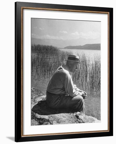 Swiss Psychiatrist Dr. Carl Jung Sitting on Stone Wall Overlooking Lake Zurich-Dmitri Kessel-Framed Premium Photographic Print