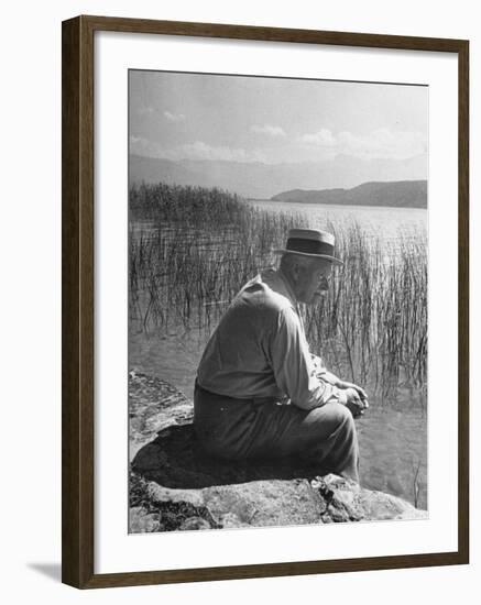 Swiss Psychiatrist Dr. Carl Jung Sitting on Stone Wall Overlooking Lake Zurich-Dmitri Kessel-Framed Premium Photographic Print