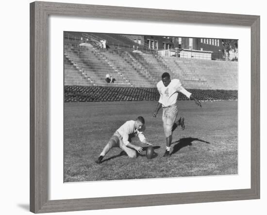 Syracuse Football Player Chuck Zimmerman Holding the Ball to Be Kicked by Teammate Jim Brown-Peter Stackpole-Framed Premium Photographic Print