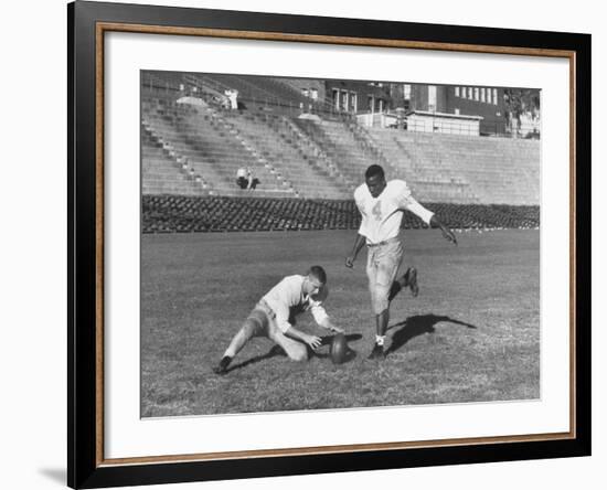 Syracuse Football Player Chuck Zimmerman Holding the Ball to Be Kicked by Teammate Jim Brown-Peter Stackpole-Framed Premium Photographic Print