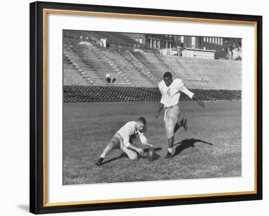 Syracuse Football Player Chuck Zimmerman Holding the Ball to Be Kicked by Teammate Jim Brown-Peter Stackpole-Framed Premium Photographic Print