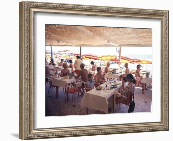 Taking Lunch in a Shaded Restaurant by the Shore in Juan Les Pins on the French Riviera, France-Ralph Crane-Framed Photographic Print