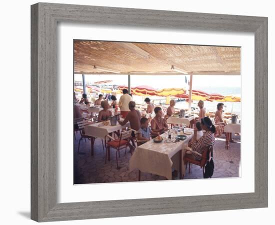 Taking Lunch in a Shaded Restaurant by the Shore in Juan Les Pins on the French Riviera, France-Ralph Crane-Framed Photographic Print