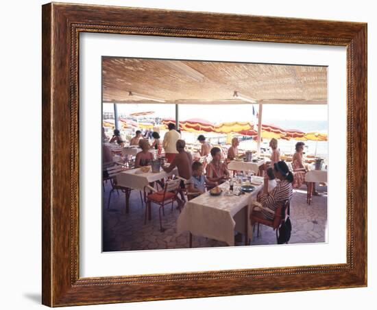 Taking Lunch in a Shaded Restaurant by the Shore in Juan Les Pins on the French Riviera, France-Ralph Crane-Framed Photographic Print