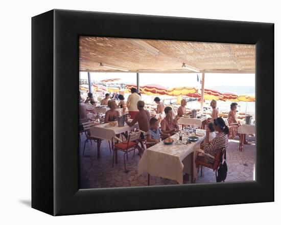 Taking Lunch in a Shaded Restaurant by the Shore in Juan Les Pins on the French Riviera, France-Ralph Crane-Framed Premier Image Canvas