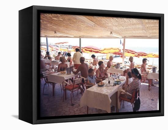 Taking Lunch in a Shaded Restaurant by the Shore in Juan Les Pins on the French Riviera, France-Ralph Crane-Framed Premier Image Canvas